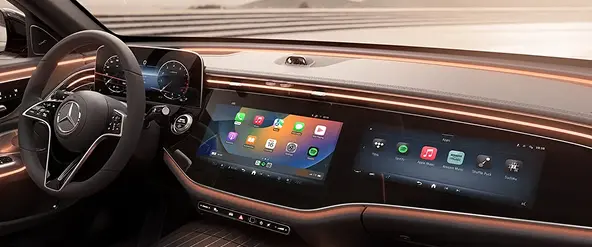 Mercedes-Benz E-Class dashboard with wood trim and dual widescreen displays