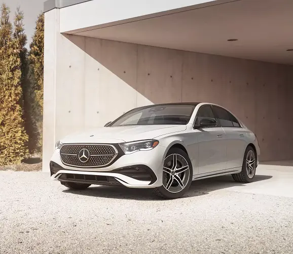 White Mercedes-Benz E-Class sedan parked, front three-quarter view