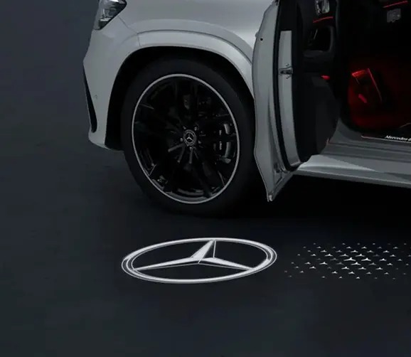 Mercedes-Benz GLS alloy wheel with a three-pointed star logo projected on the ground