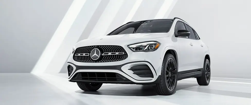 White Mercedes-Benz GLA compact SUV in a bright studio, front three-quarter view