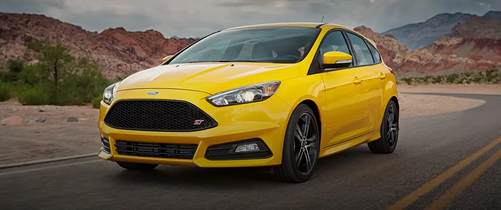 Yellow Ford Focus ST driving on a desert highway