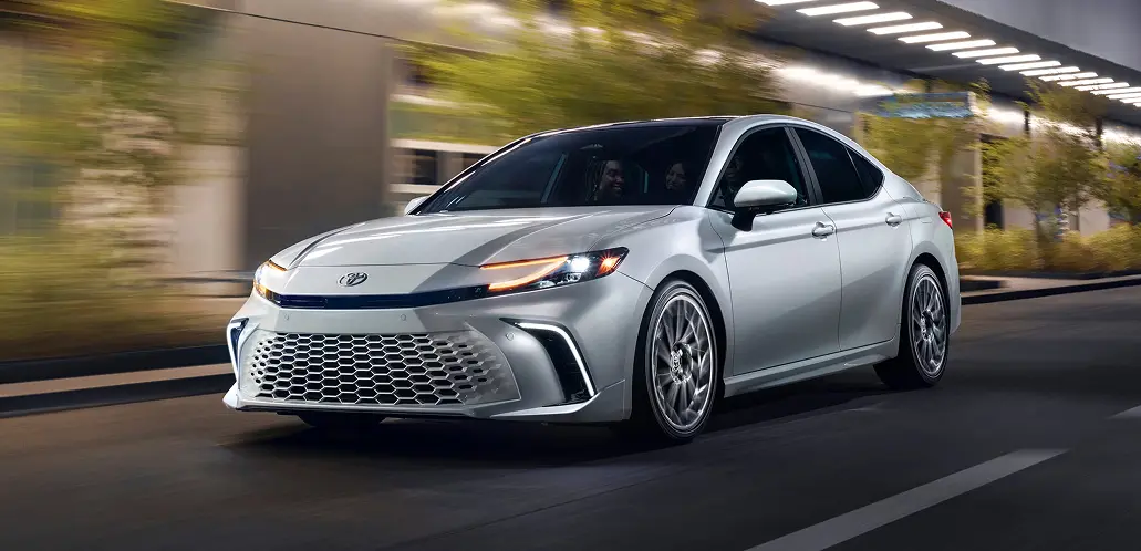 Toyota Camry front three-quarter view driving through a city street