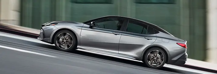 Toyota Camry side profile driving up an incline