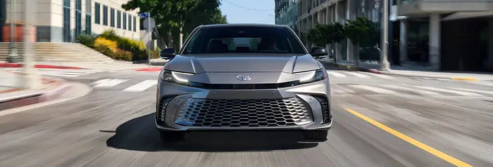 Toyota Camry front view driving on a city street
