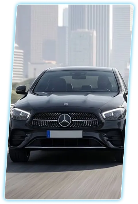 Mercedes-Benz sedan front view against a city skyline