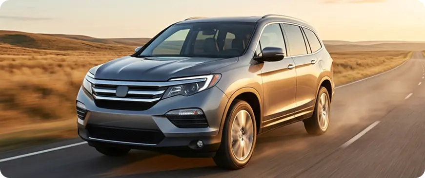 Gray Honda Pilot SUV driving on an open road