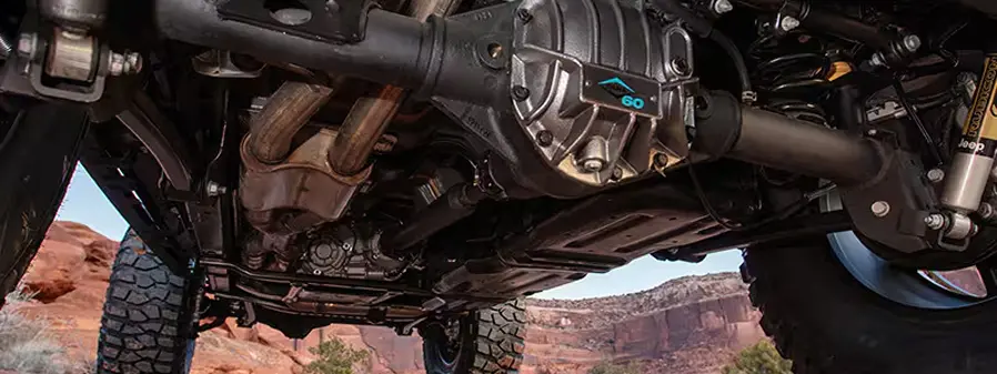Underside view of a Jeep Wrangler showing the axle and sway bar