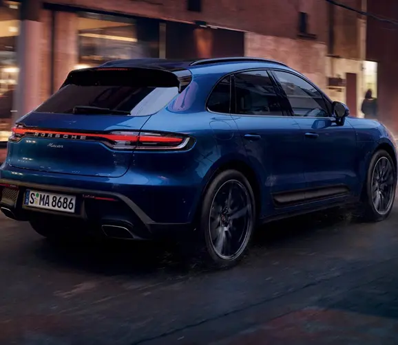 Blue Porsche Macan rear three-quarter view