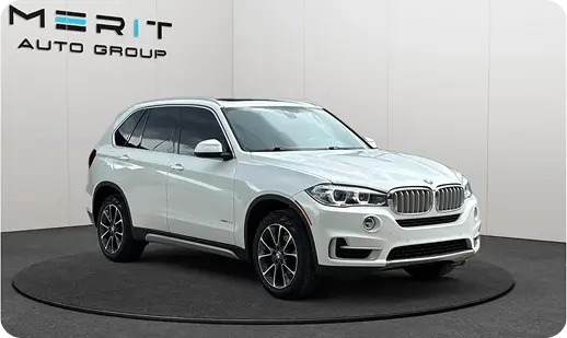 White BMW X5 SUV on a studio turntable