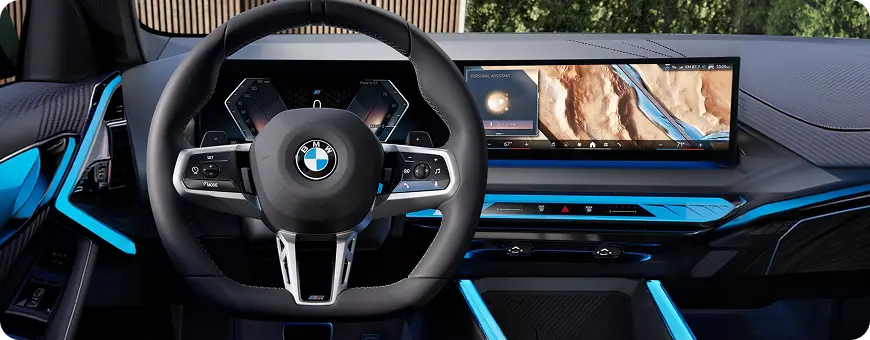 BMW X3 cabin with blue ambient lighting and steering wheel