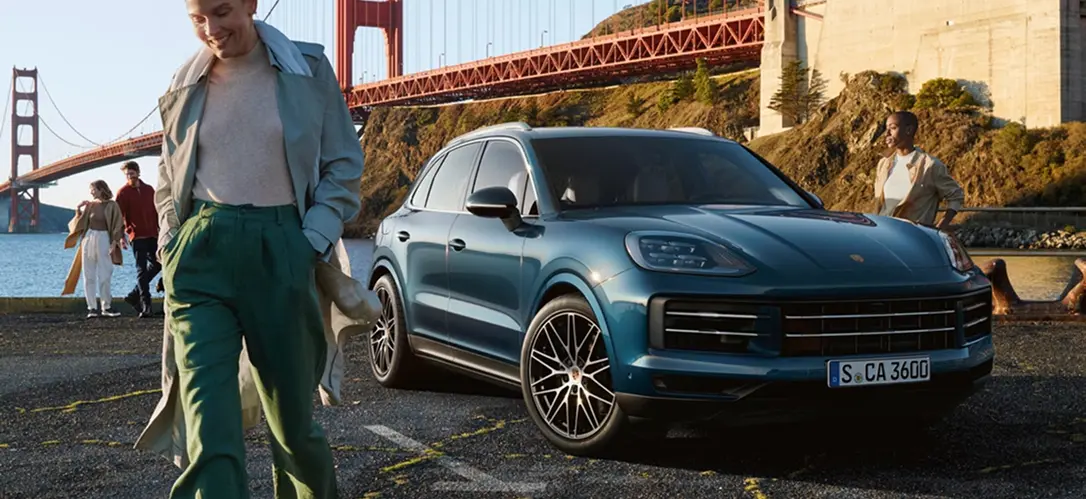 Teal Porsche Cayenne parked near the Golden Gate Bridge