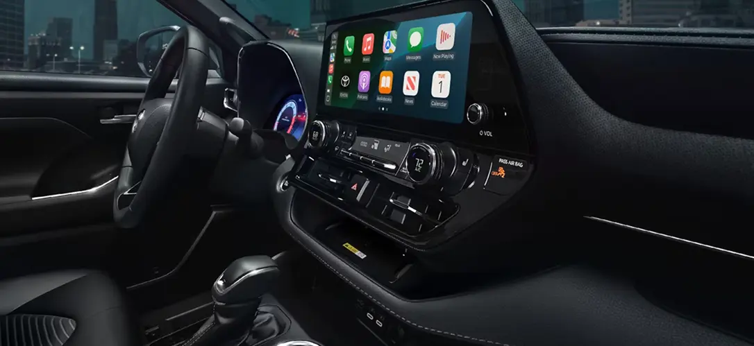 Toyota Highlander interior dashboard showing the touchscreen with Apple CarPlay