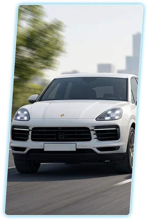 White Porsche Cayenne front view against a city skyline