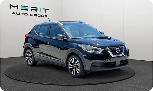 Dark blue Nissan Kicks SUV on a studio turntable
