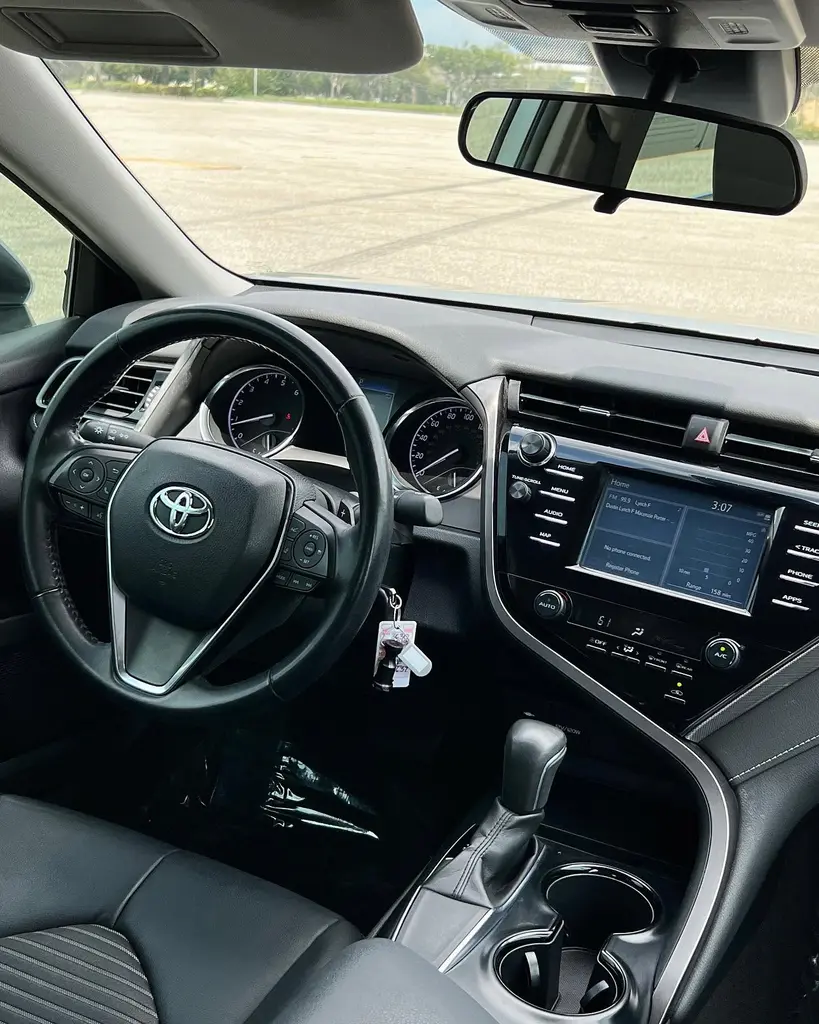 Toyota Camry interior dashboard, instrument cluster and centre screen.
