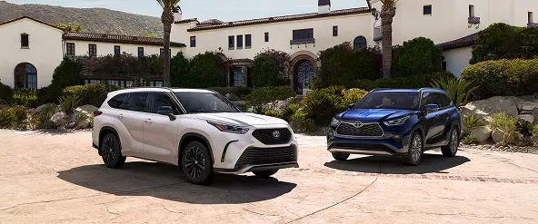 Two Toyota Highlanders parked in front of a house