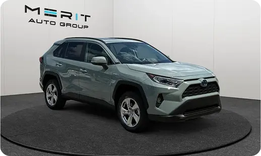 Green Toyota RAV4 SUV on a studio turntable, front three-quarter view