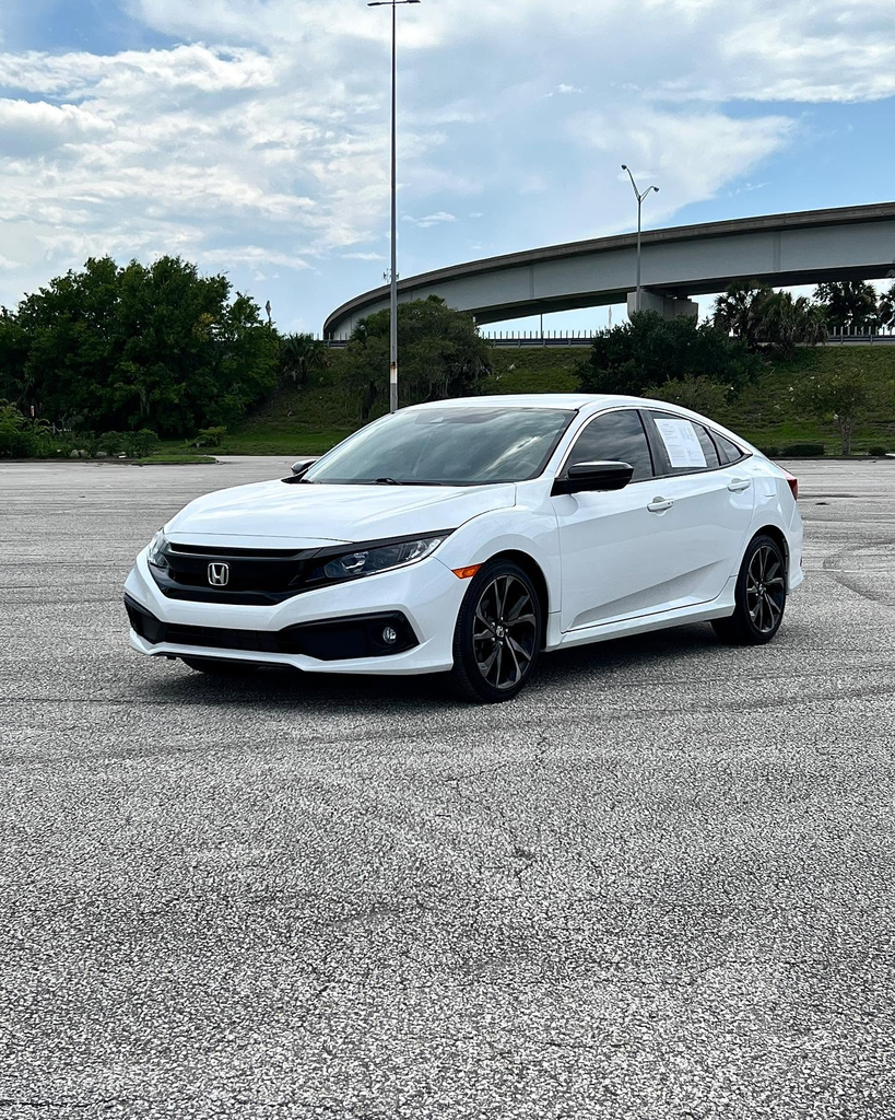 White Honda Civic photographed from the front three-quarter angle.