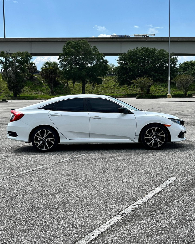 White Honda Civic in full side profile.