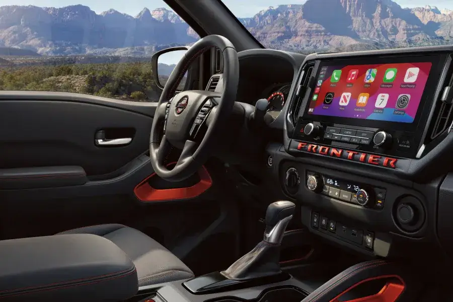 Driver side with dashboard of a 2025 Nissan Frontier