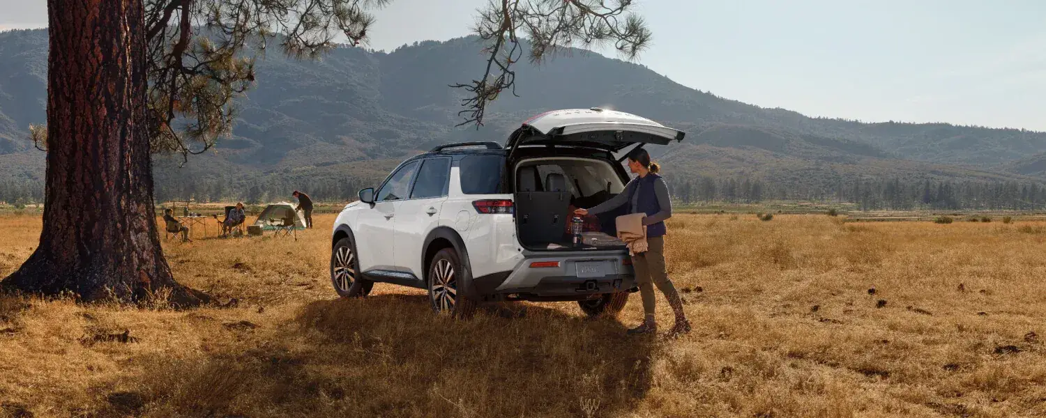 2025 Red Nissan Pathfinder out on a dirt campsite