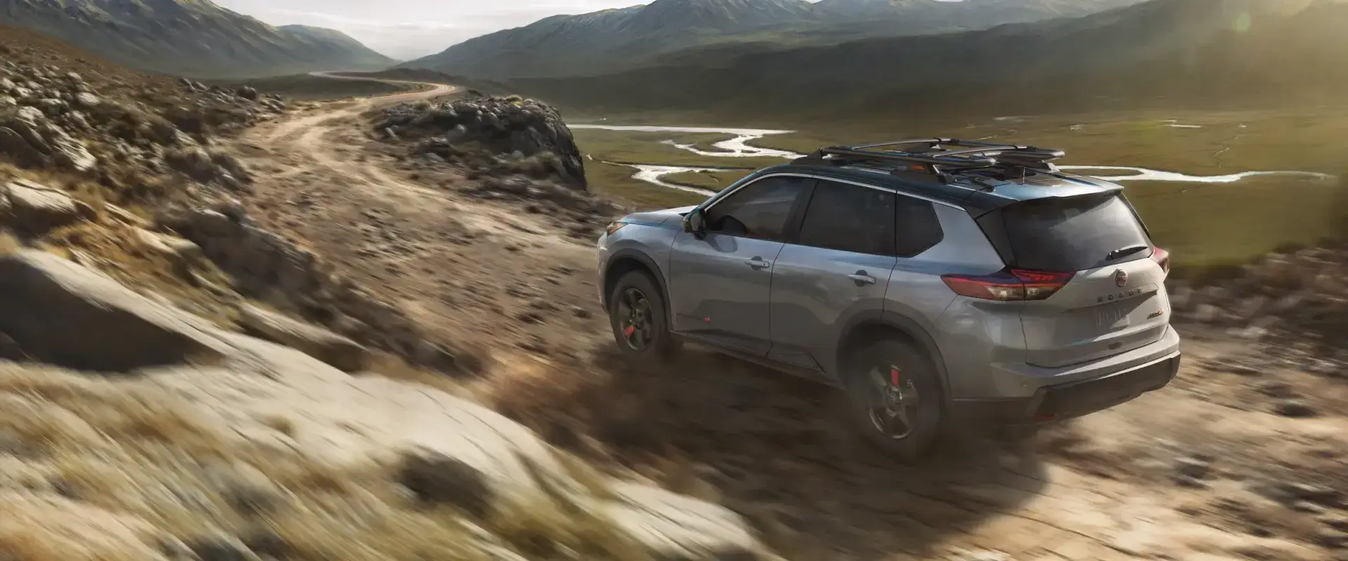 2025 Red Nissan Frontier out on a dirt road