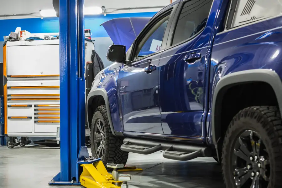 Diesel pickup truck on a lift in the North Texas Truck Stop service bay