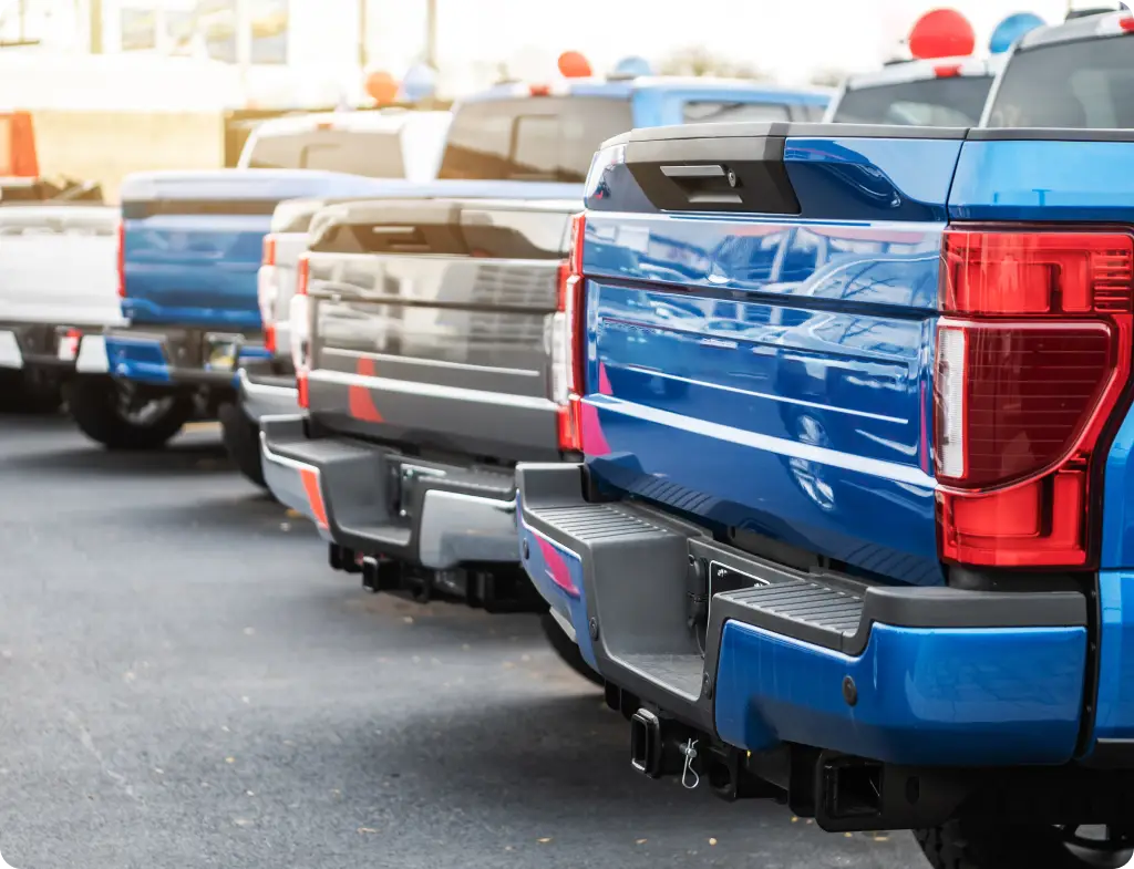Row of diesel pickup trucks parked tailgate to tailgate at North Texas Truck Stop