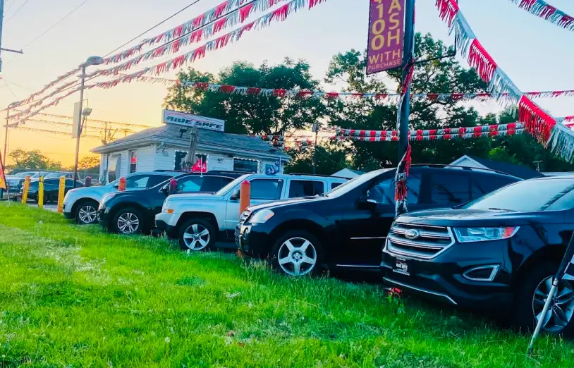 Used vehicles lined up outside Northwest Indiana Auto Outlet dealership lot.