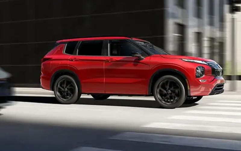 Nissan red pathfinder on the road