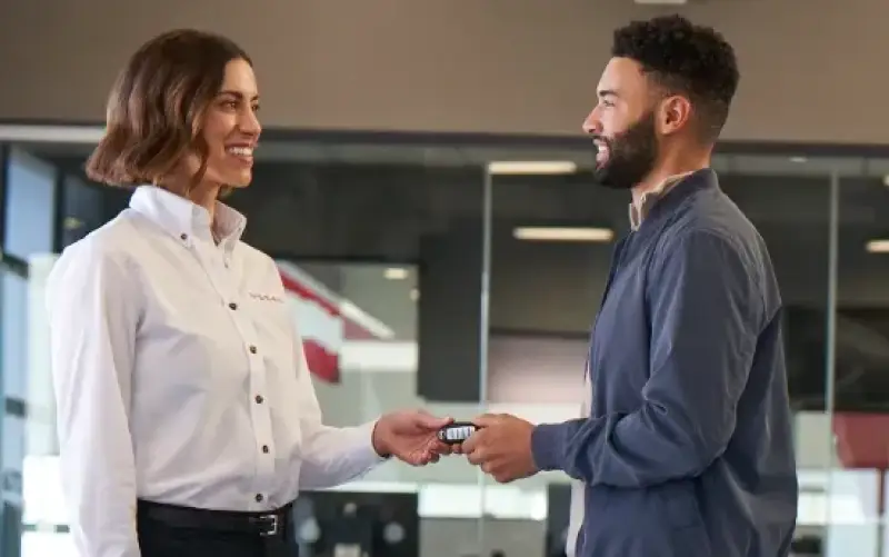 Nissan employee chatting with a customer
