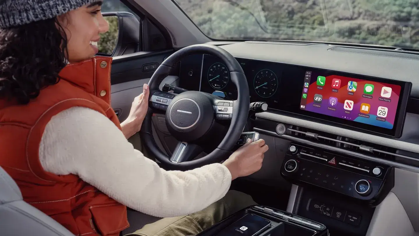 Driver using Apple CarPlay on the 2026 Hyundai Tucson 12.3-inch touchscreen
