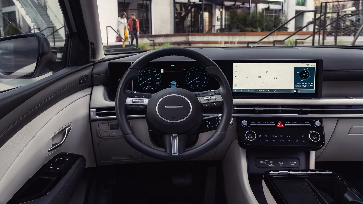 2026 Hyundai Tucson gray dashboard with steering wheel and touchscreen, seen from the back seat