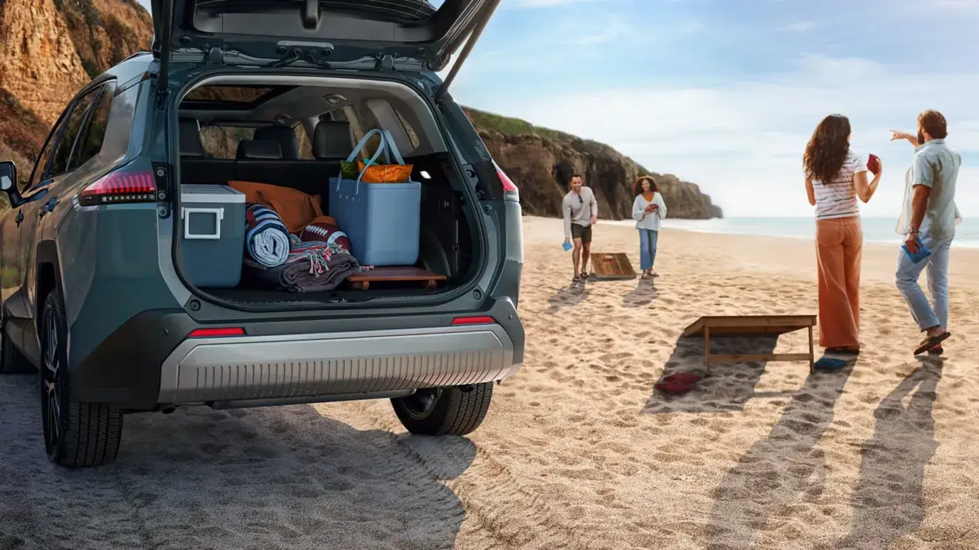 2026 Toyota RAV4 with its liftgate open and cargo area packed for a beach day