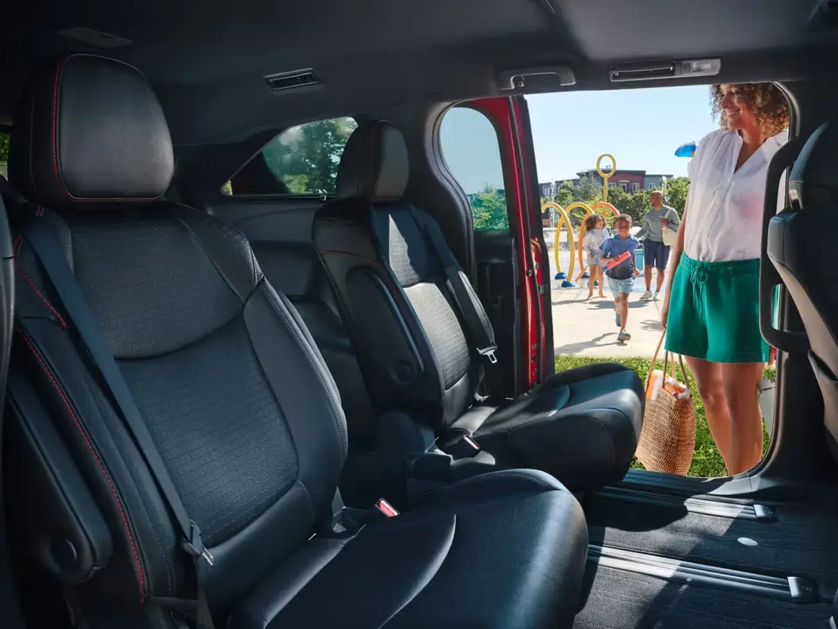 2026 Toyota Sienna black second-row seats seen through the open sliding door