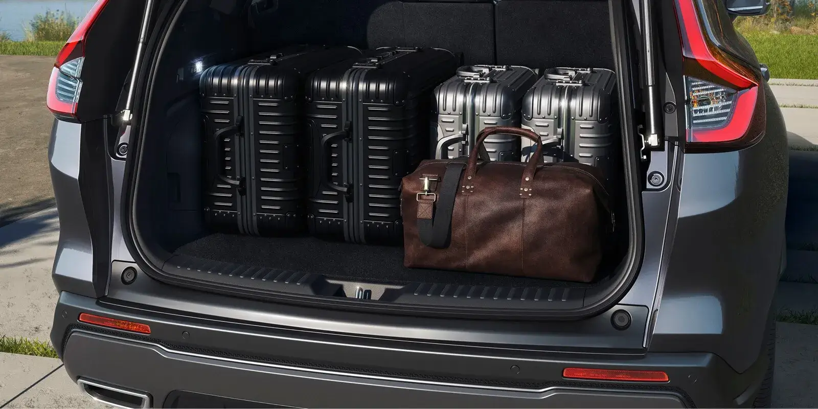 2027 Honda CR-V cargo area loaded with four suitcases and a duffel bag