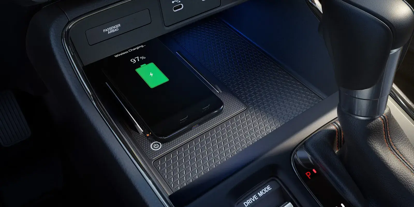 2027 Honda CR-V center console with wireless phone charging pad and blue ambient lighting