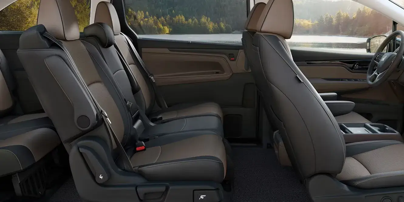 2027 Honda Odyssey dark leather second- and third-row seats seen from the side