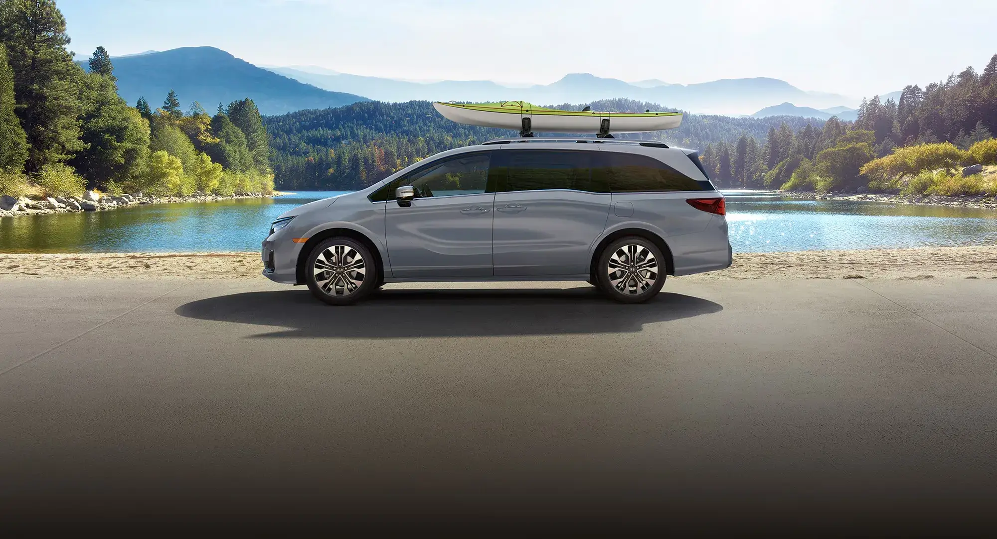 2027 Honda Odyssey Elite in Sonic Gray Pearl with a roof kayak, side view