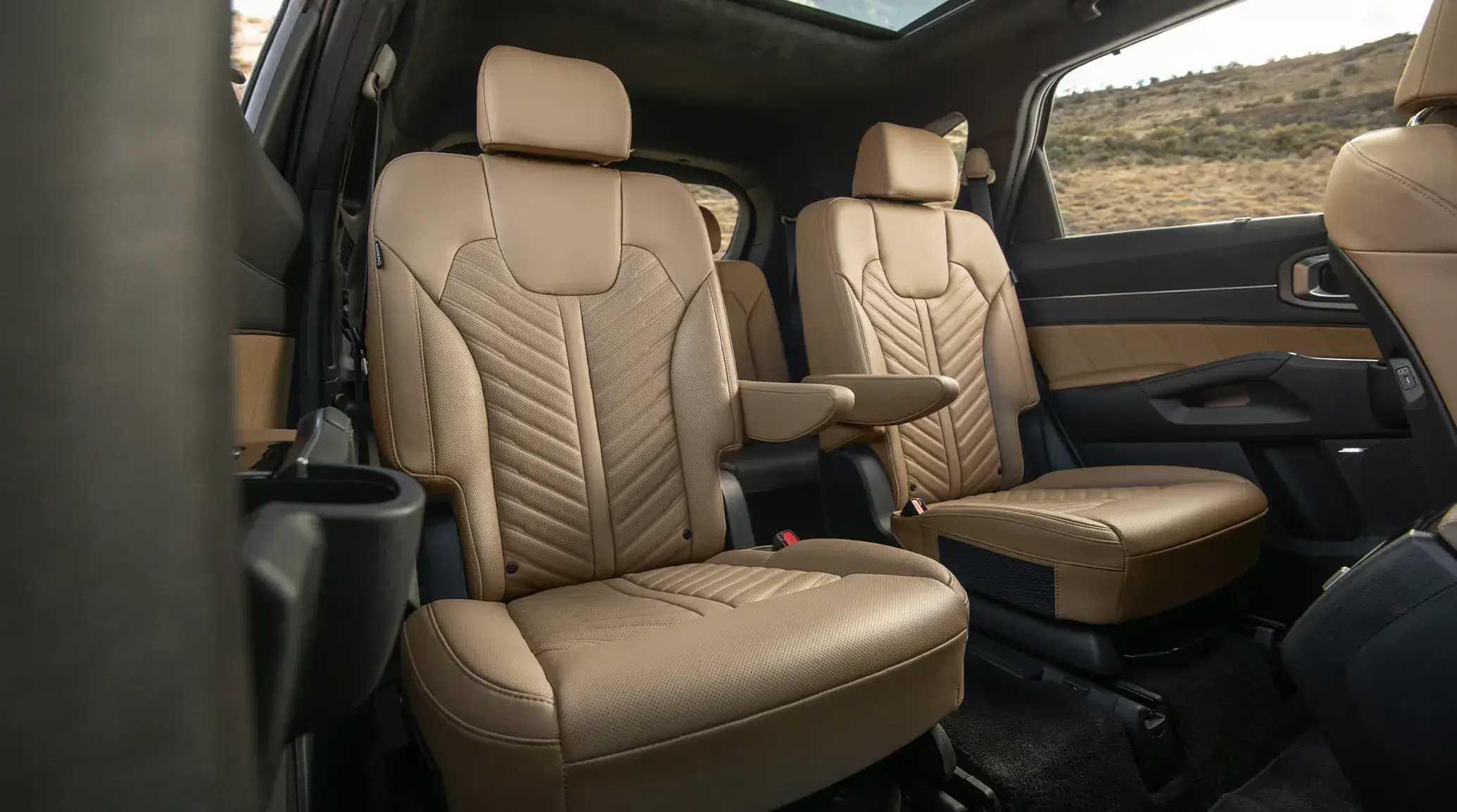 Kia Sorento tan second-row captain's chairs with the third row behind