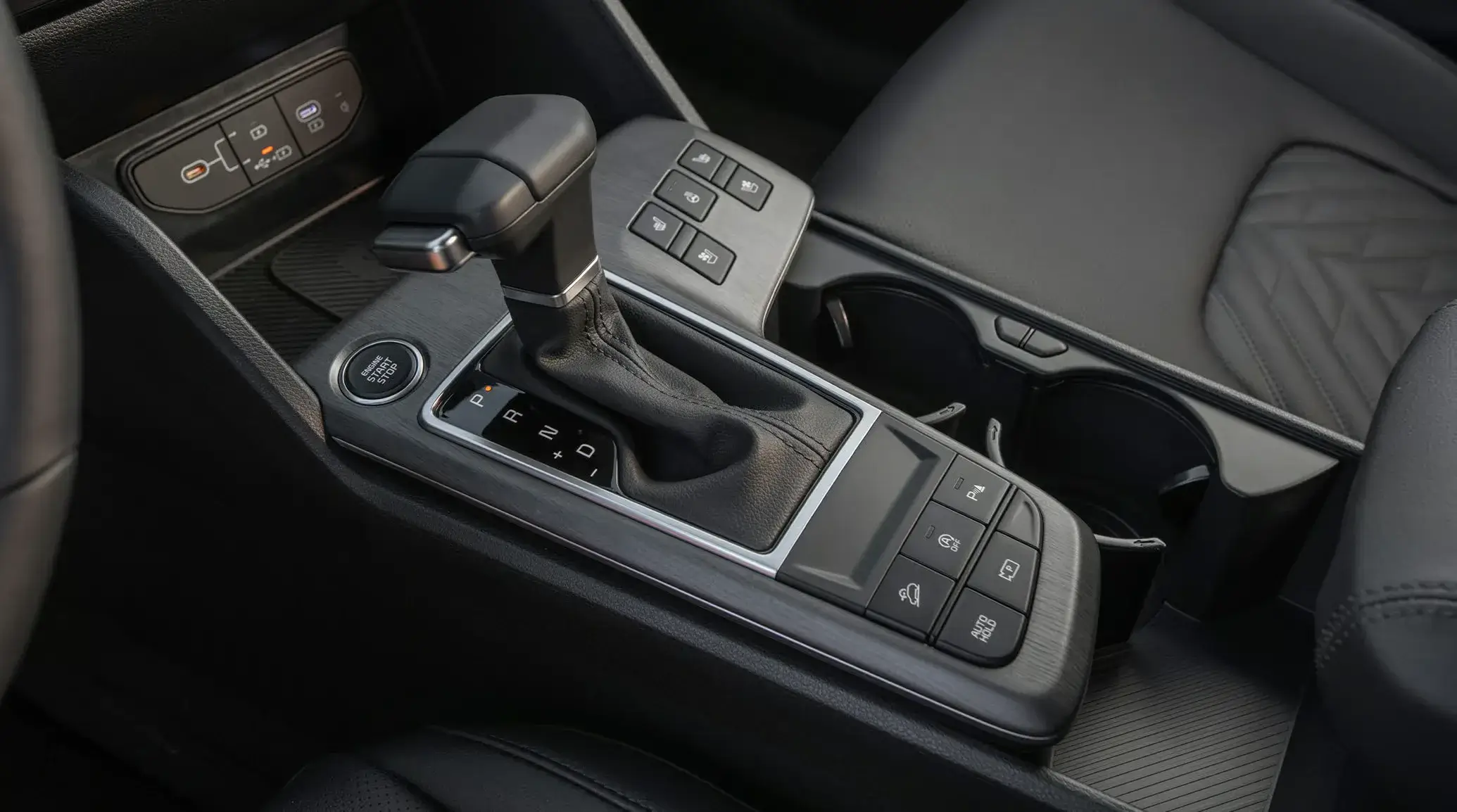2027 Kia Sportage center console with gear selector, start button and seat controls