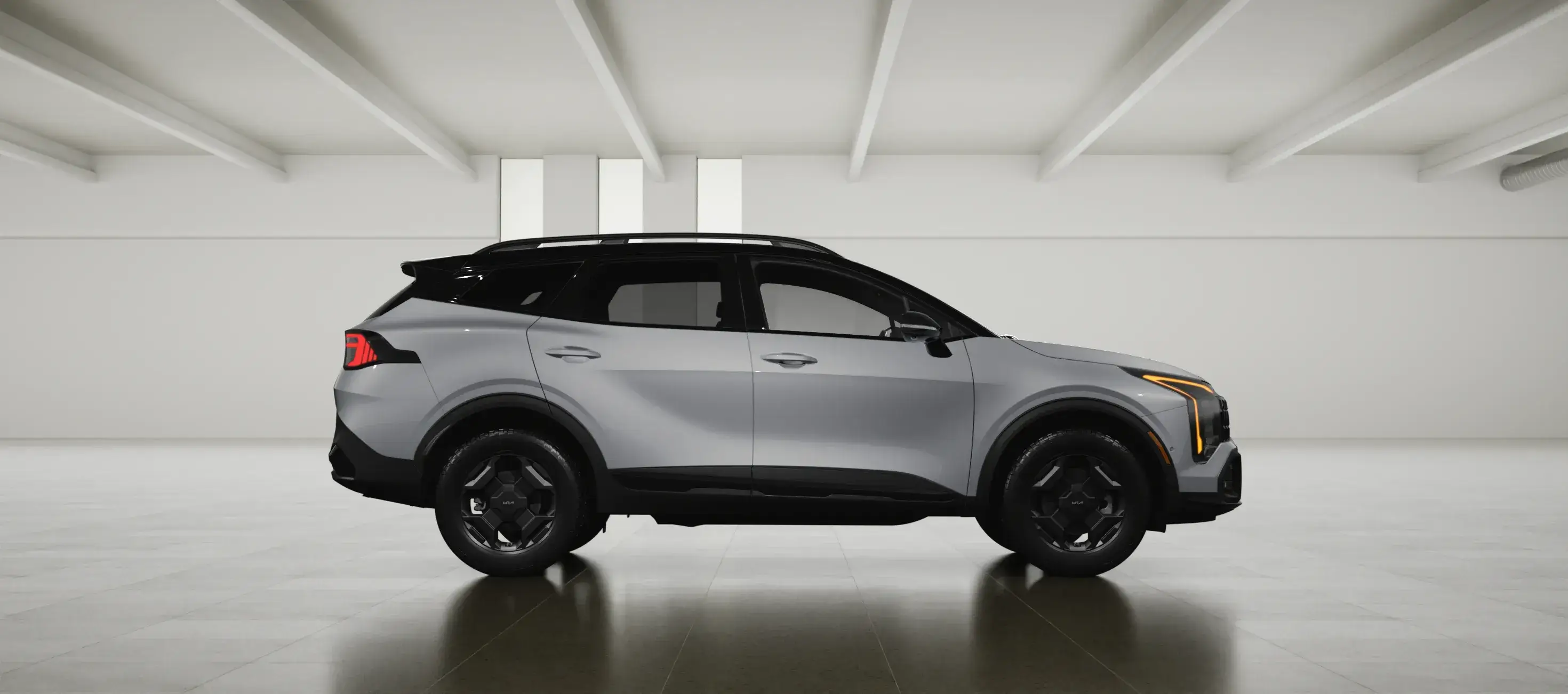 Silver 2027 Kia Sportage facing right in a white studio, side view