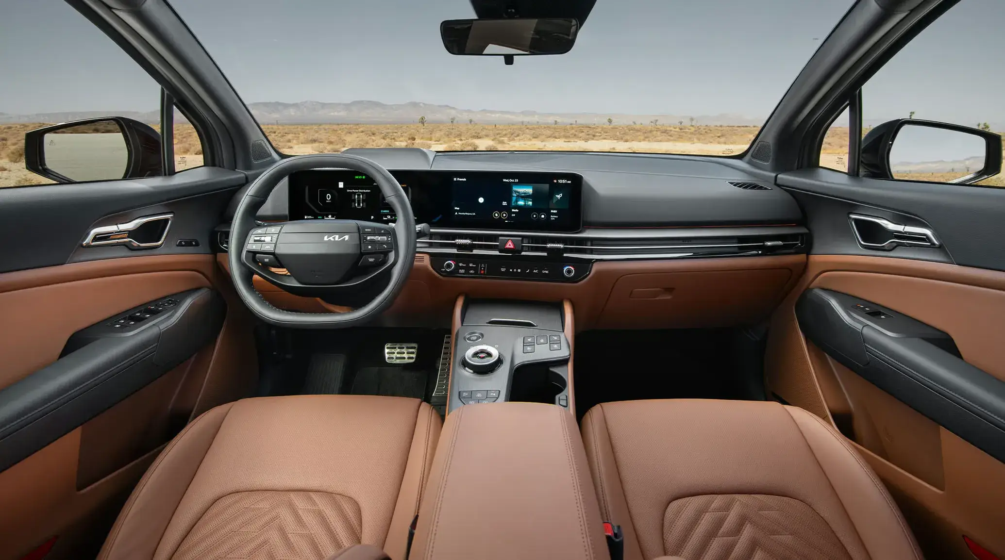 2027 Kia Sportage brown interior and dual 12.3-inch screens, seen from the back seat