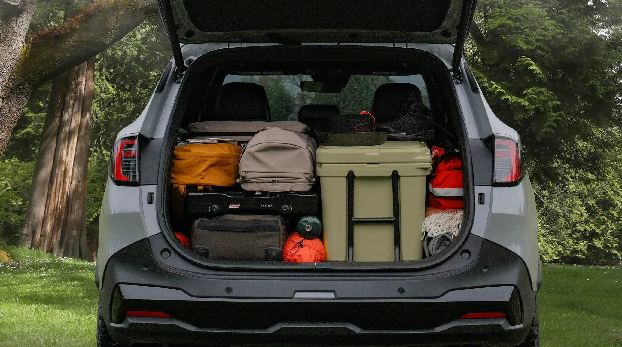 2027 Kia Sportage cargo area packed with a cooler and camping gear
