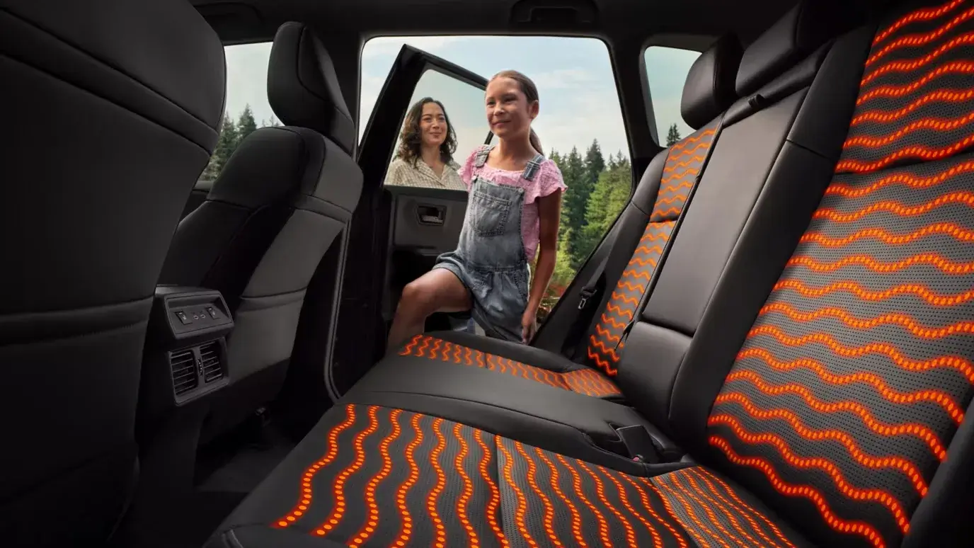 2026 Toyota RAV4 rear seats with heated-seat glow, seen from inside the cabin