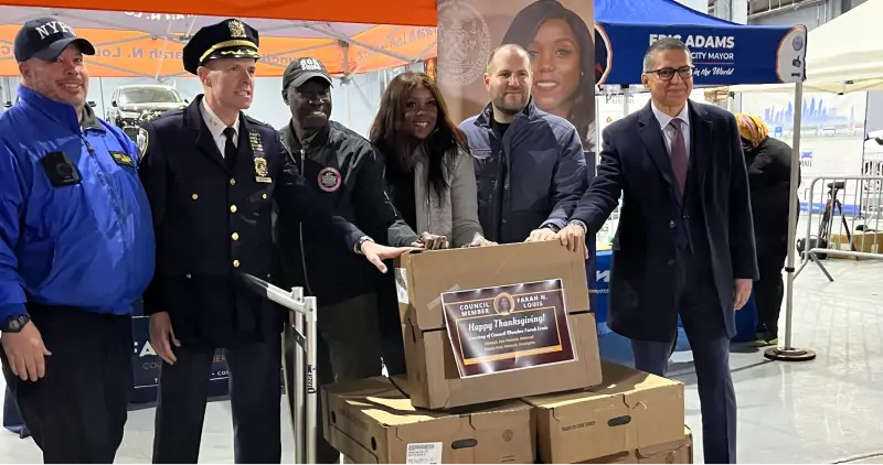 Community leaders with donation boxes at a Plaza Auto Mall giving back event