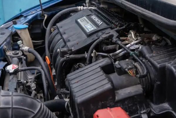 Service technician inspecting the transmission on a Honda at Plaza Honda