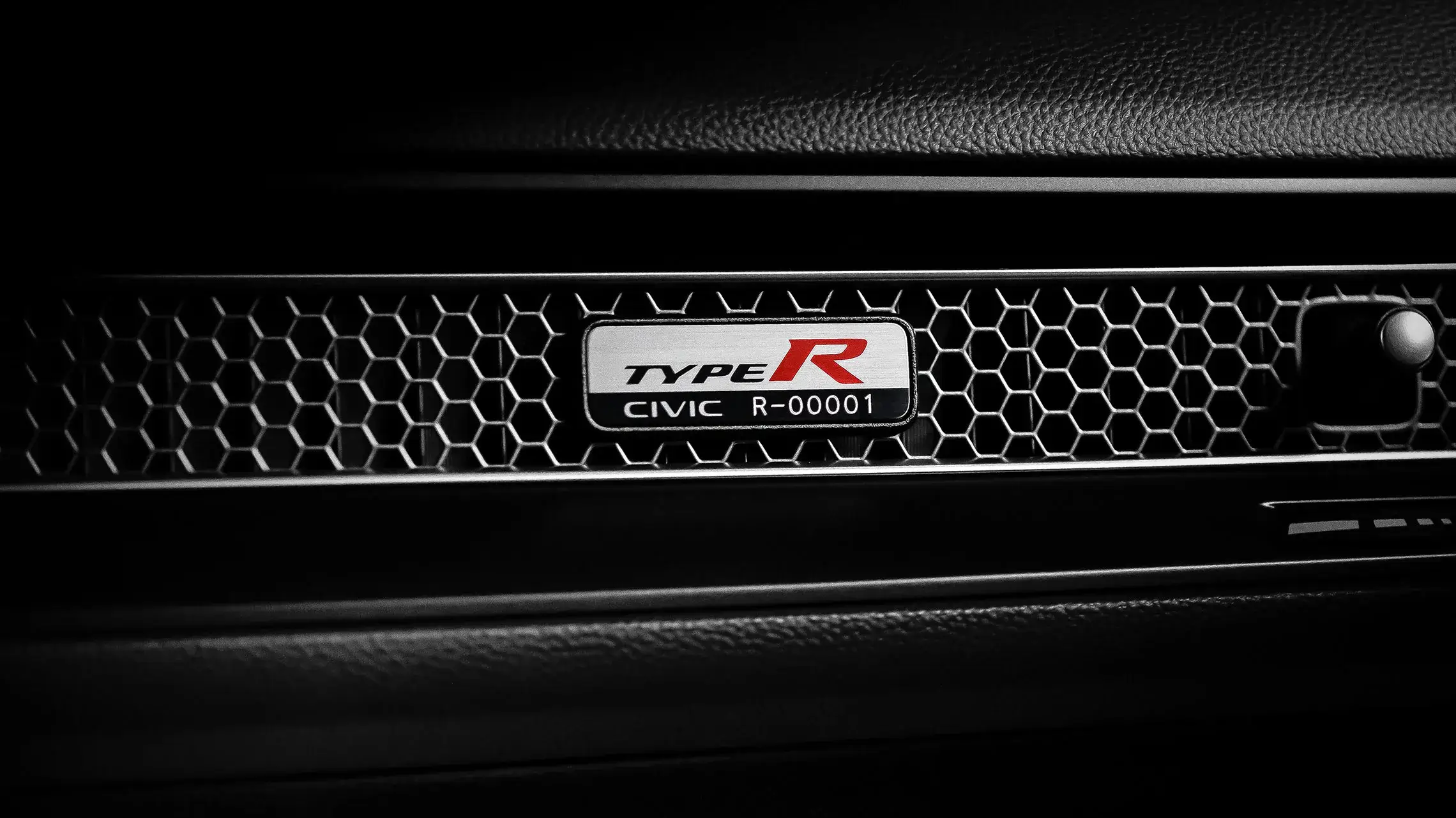 Individually numbered Honda Civic Type R serial plate mounted on the dashboard