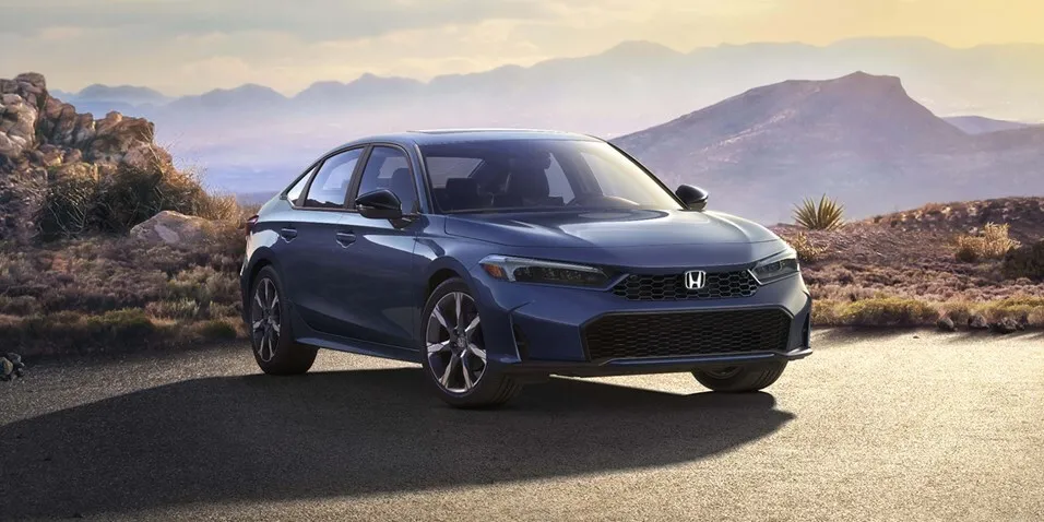 Blue Honda Civic sedan on a desert road, front three-quarter view