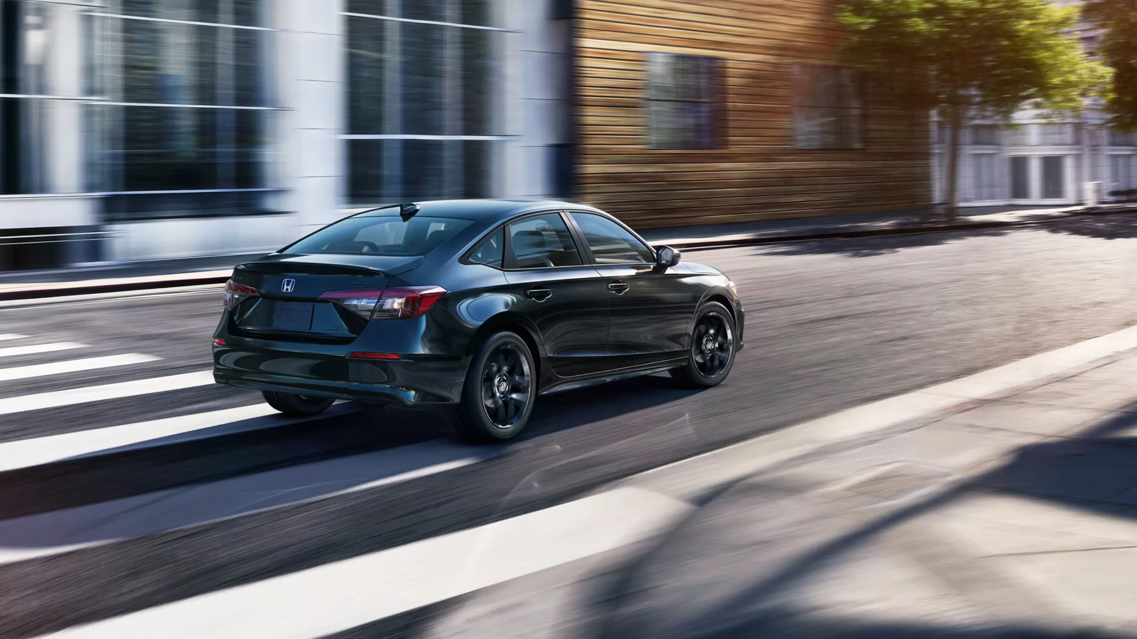 Honda Civic Sedan Sport Hybrid in Crystal Black Pearl, rear three-quarter view, available at Plaza Honda Brooklyn